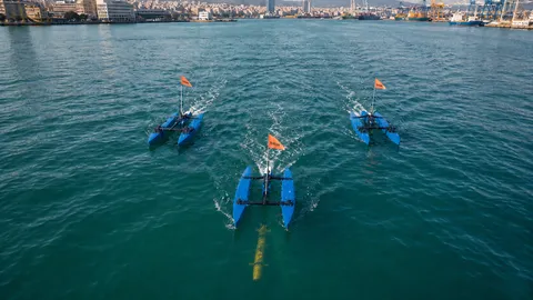 Three BlueBoat USVs in triangular formation, UUV below